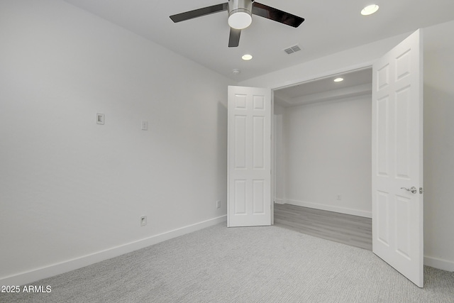 unfurnished bedroom featuring light colored carpet and ceiling fan