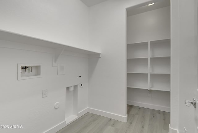 clothes washing area with gas dryer hookup, washer hookup, light hardwood / wood-style flooring, and electric dryer hookup