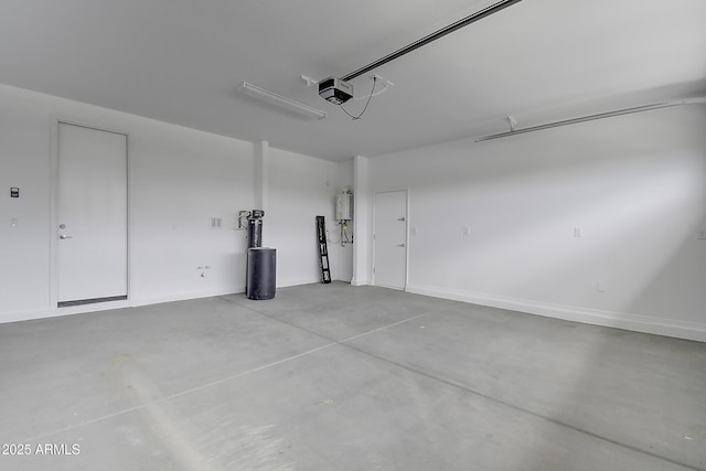 garage featuring a garage door opener and water heater