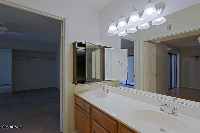 9355 N 91st St Unit 116, Scottsdale, AZ 85258 - bathroom featuring double vanity, visible vents, a ceiling fan, and a sink