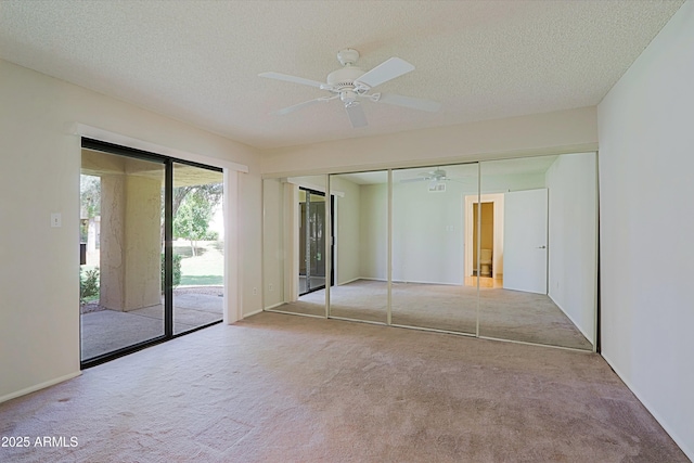 9355 N 91st St Unit 116, Scottsdale, AZ 85258 - unfurnished bedroom featuring a ceiling fan, carpet flooring, access to outside, and a textured ceiling
