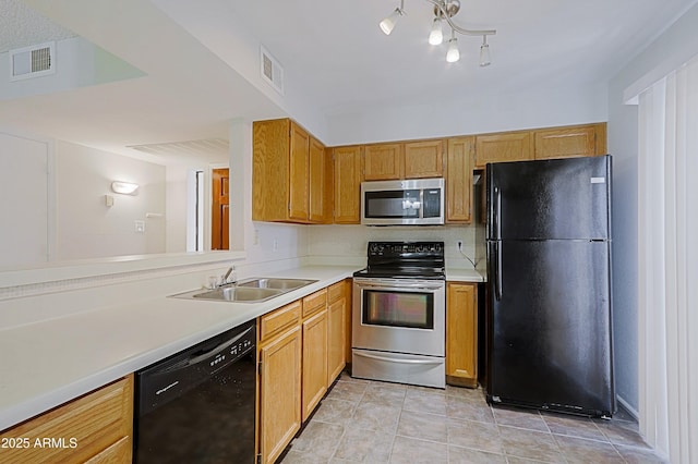 9355 N 91st St Unit 116, Scottsdale, AZ 85258 - kitchen with light countertops, visible vents, a sink, and black appliances