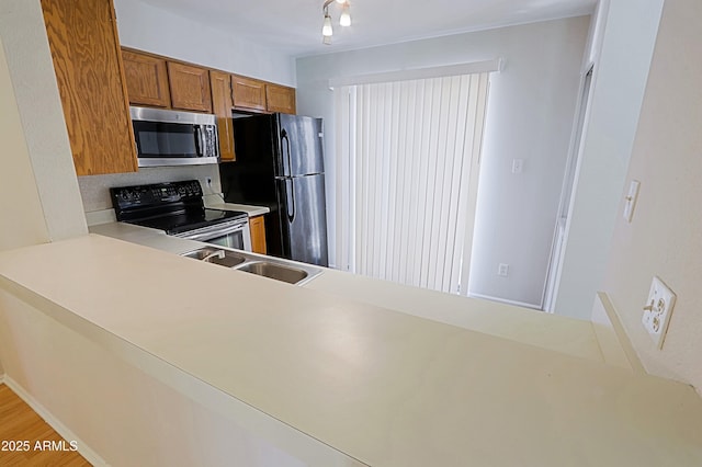 9355 N 91st St Unit 116, Scottsdale, AZ 85258 - kitchen with stainless steel microwave, electric range, freestanding refrigerator, brown cabinets, and light countertops