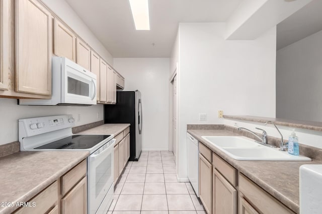 kitchen with white appliances, light tile patterned floors, sink, and light brown cabinets