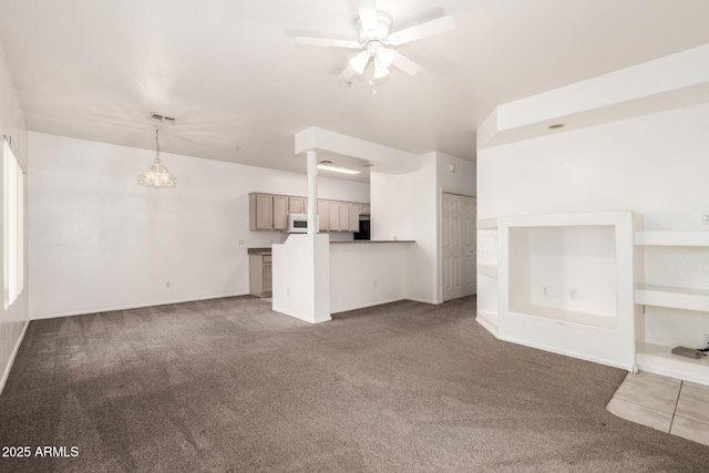 unfurnished living room featuring ceiling fan and carpet