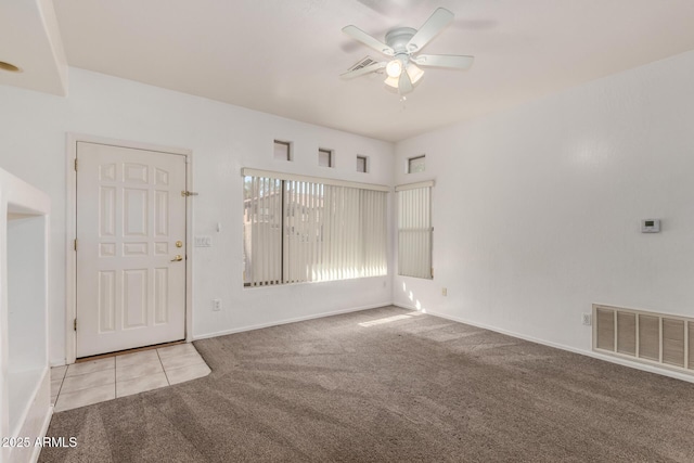 interior space with light carpet and ceiling fan