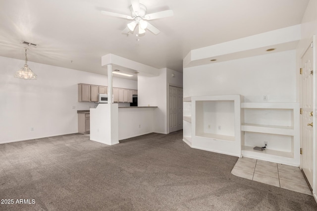 unfurnished living room featuring carpet floors and ceiling fan