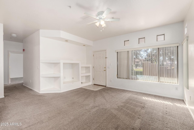 unfurnished living room with ceiling fan and carpet floors