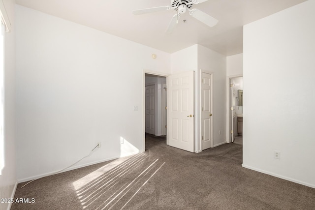 interior space with ceiling fan and dark carpet