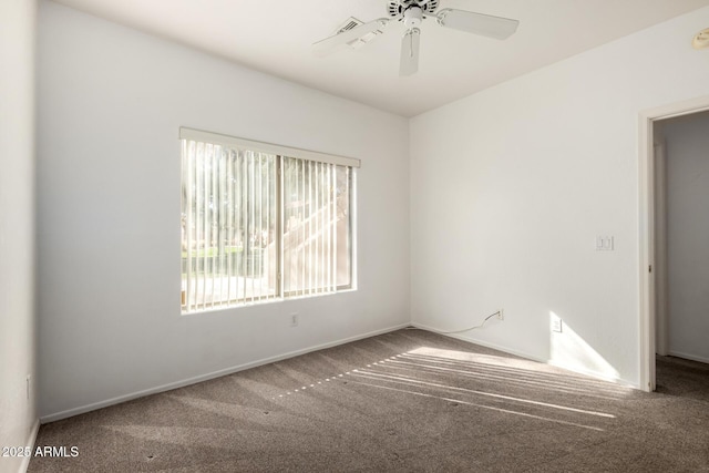 carpeted spare room with ceiling fan