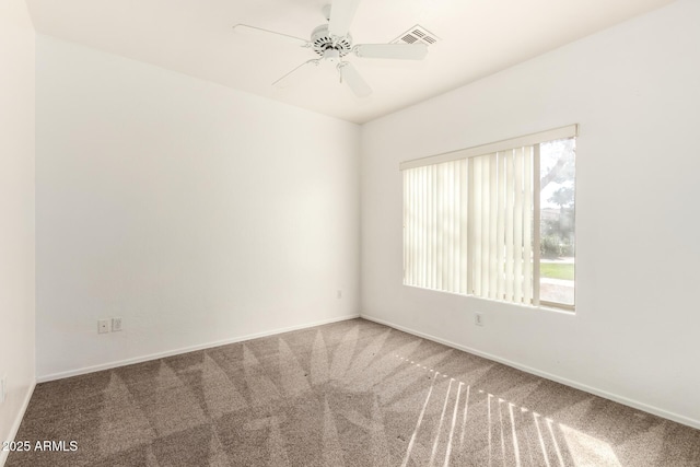 carpeted spare room with ceiling fan