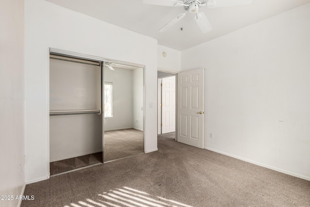 unfurnished bedroom with ceiling fan, a closet, and dark colored carpet