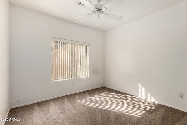 spare room featuring ceiling fan and carpet