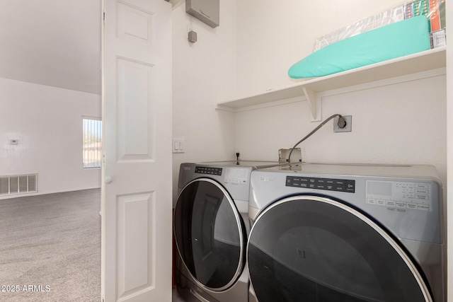 clothes washing area with carpet floors and washing machine and dryer