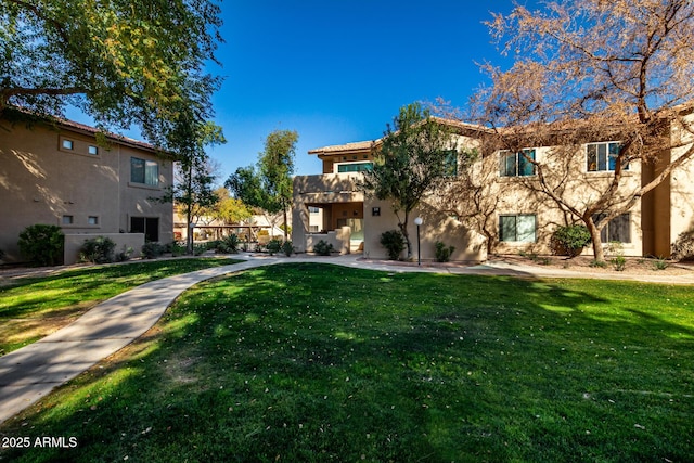 view of home's community featuring a yard