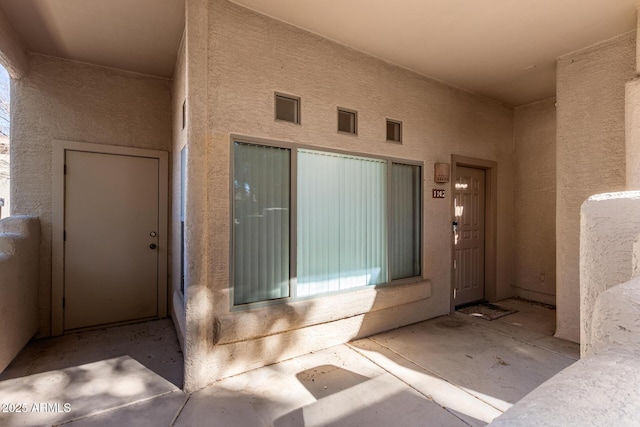 doorway to property with a patio area