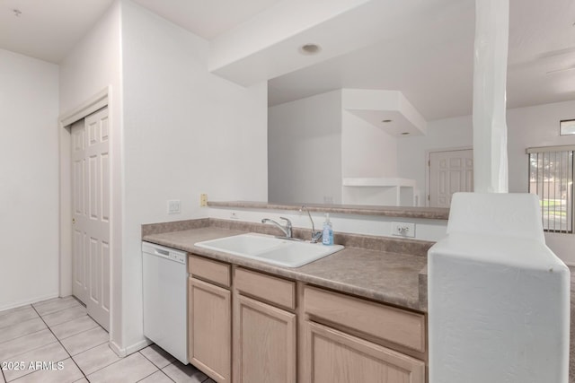 kitchen with dishwasher, sink, light tile patterned floors, and light brown cabinetry