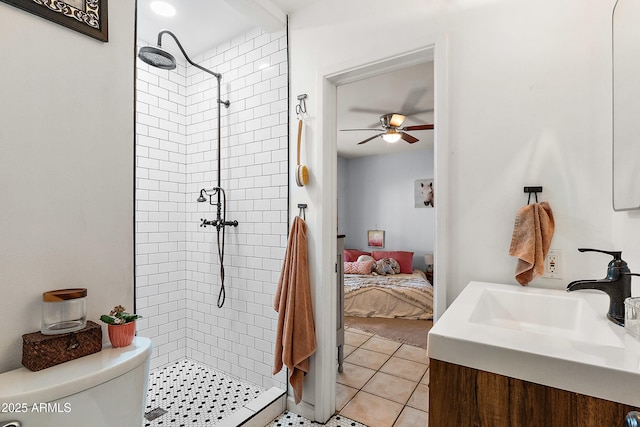 bathroom featuring tile patterned floors, toilet, a tile shower, a ceiling fan, and ensuite bathroom