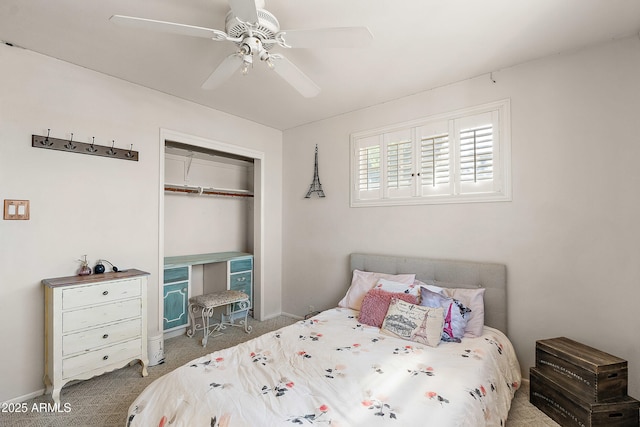 carpeted bedroom with ceiling fan, baseboards, and a closet