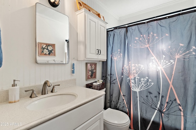 bathroom with toilet, curtained shower, vanity, and crown molding