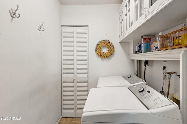 laundry area with cabinet space and separate washer and dryer
