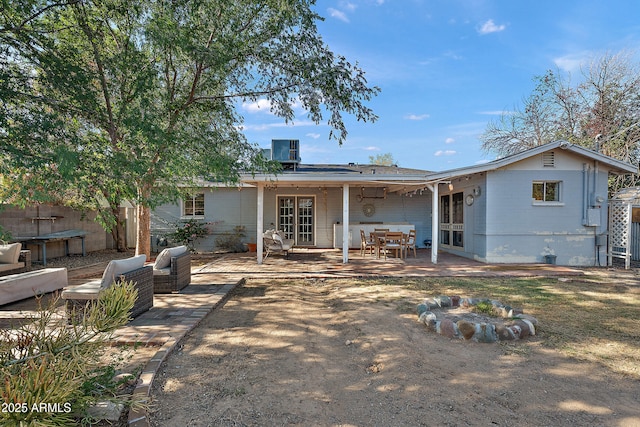 rear view of property featuring a patio and french doors