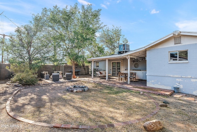 rear view of house featuring a patio, central air condition unit, french doors, and a fenced backyard