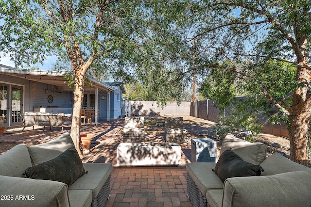 view of patio with an outdoor hangout area, french doors, and a fenced backyard