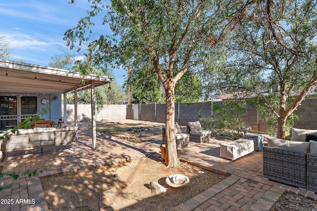 view of patio with an outdoor hangout area and a fenced backyard
