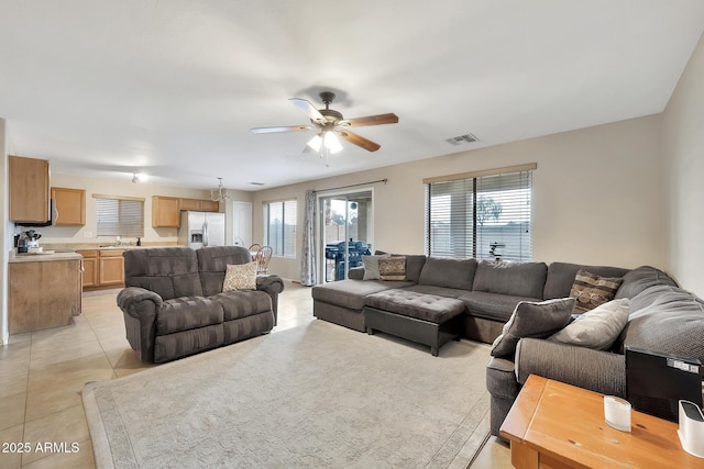 living room with ceiling fan, a healthy amount of sunlight, sink, and light tile patterned floors