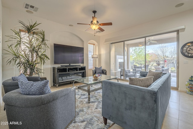 living room featuring a wealth of natural light, ceiling fan, and light tile patterned flooring