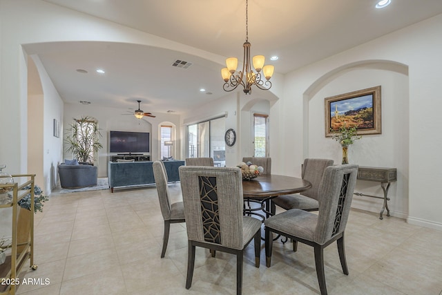 dining room featuring ceiling fan with notable chandelier and light tile patterned floors