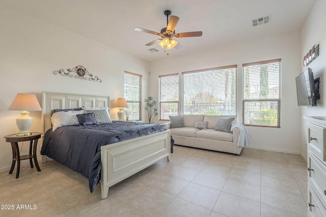 tiled bedroom featuring ceiling fan and multiple windows