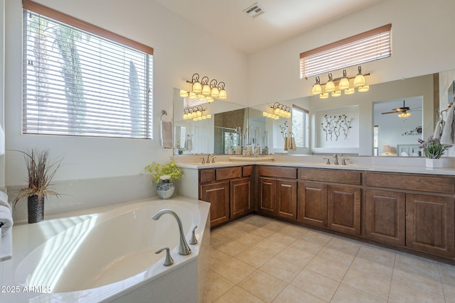 bathroom with tile patterned flooring, vanity, and shower with separate bathtub