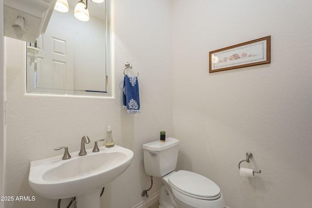 bathroom featuring sink and toilet