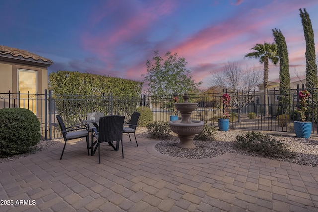 view of patio terrace at dusk