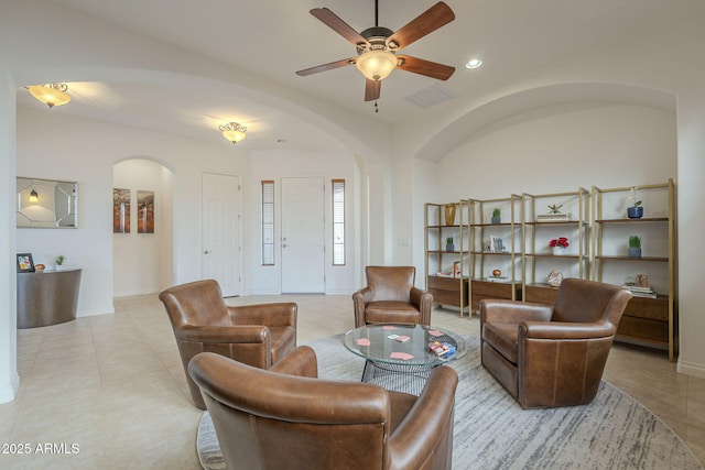 tiled living room with ceiling fan