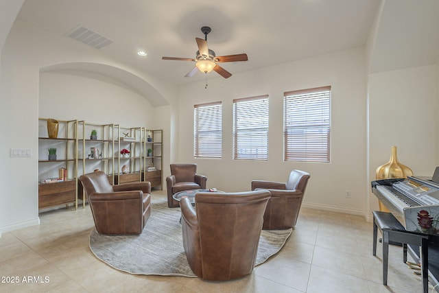 tiled living room featuring ceiling fan