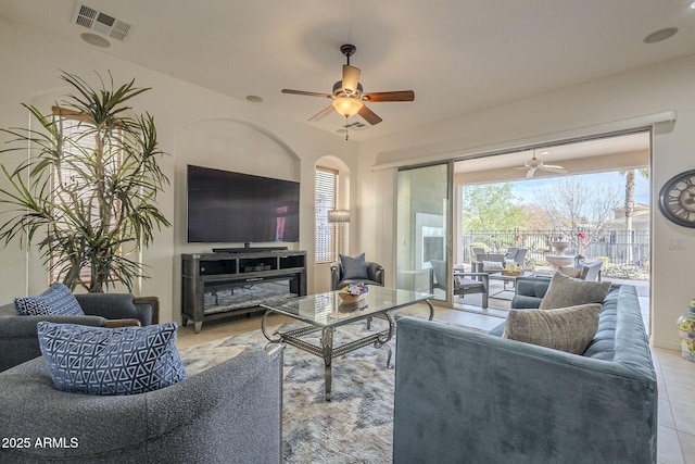 tiled living room featuring ceiling fan