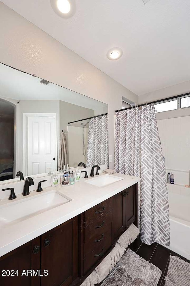 bathroom featuring tile patterned flooring, vanity, and shower / bath combo