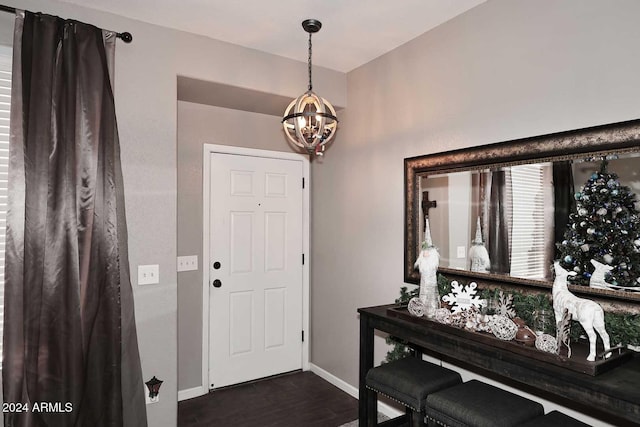 foyer entrance with a chandelier and dark hardwood / wood-style flooring