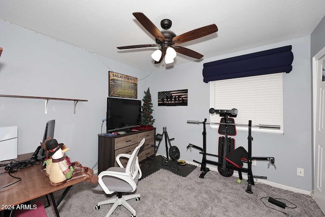 carpeted home office featuring ceiling fan