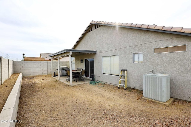 back of house with a patio area and central air condition unit