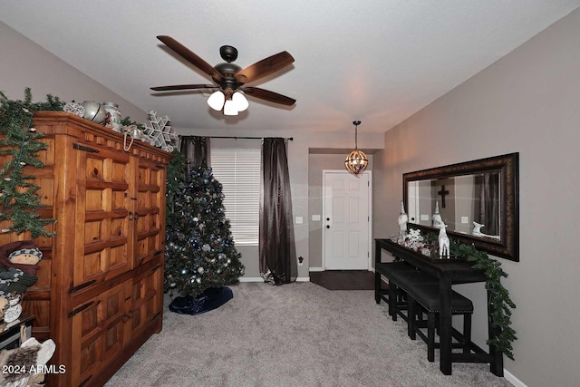 interior space featuring ceiling fan and carpet floors