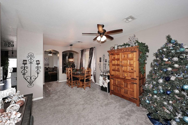 interior space featuring carpet and ceiling fan