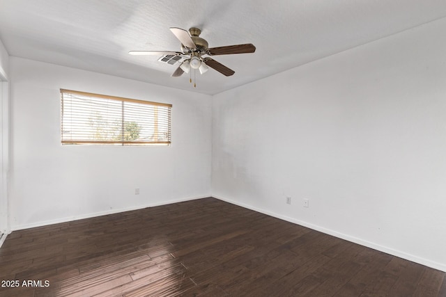 empty room featuring wood finished floors, baseboards, and ceiling fan