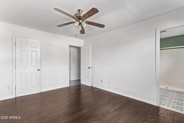 unfurnished bedroom featuring wood finished floors, baseboards, and a ceiling fan
