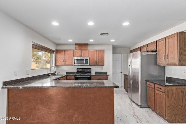 kitchen with appliances with stainless steel finishes, light marble finish floors, recessed lighting, a sink, and brown cabinets