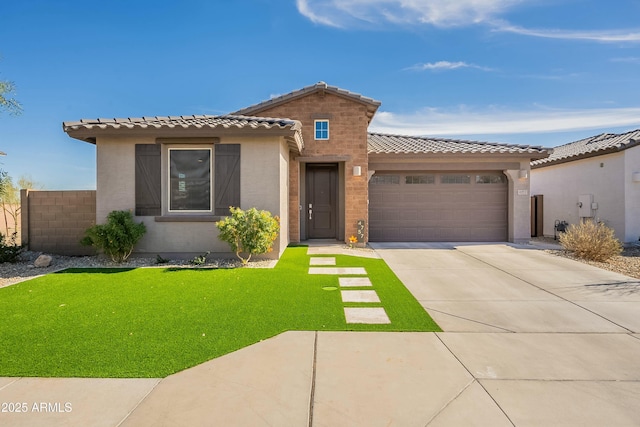 mediterranean / spanish-style house featuring a garage and a front yard