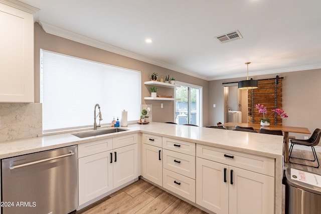 kitchen featuring light stone counters, a peninsula, a sink, stainless steel dishwasher, and pendant lighting